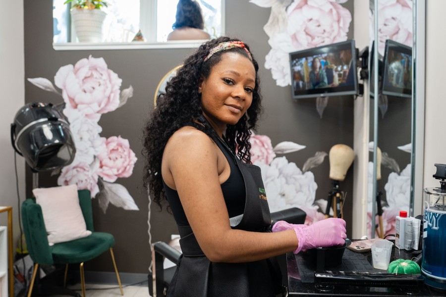LaQuana Johnson standing at table in hair salon