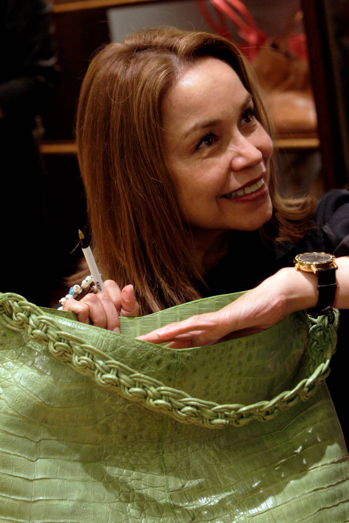 Handbag designer Nancy Gonzalez is pictured in 2008 autographing one of her bags at the Neiman Marcus store in Bal Harbour. The Colombian designer was in town to show her latest collection. MIAMI HERALD STAFF