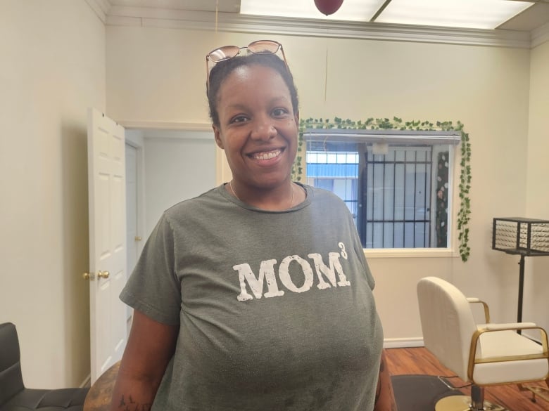 Woman with green shirt smiles.