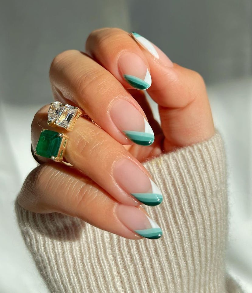 Try almond-shaped green chevron French tip nails.