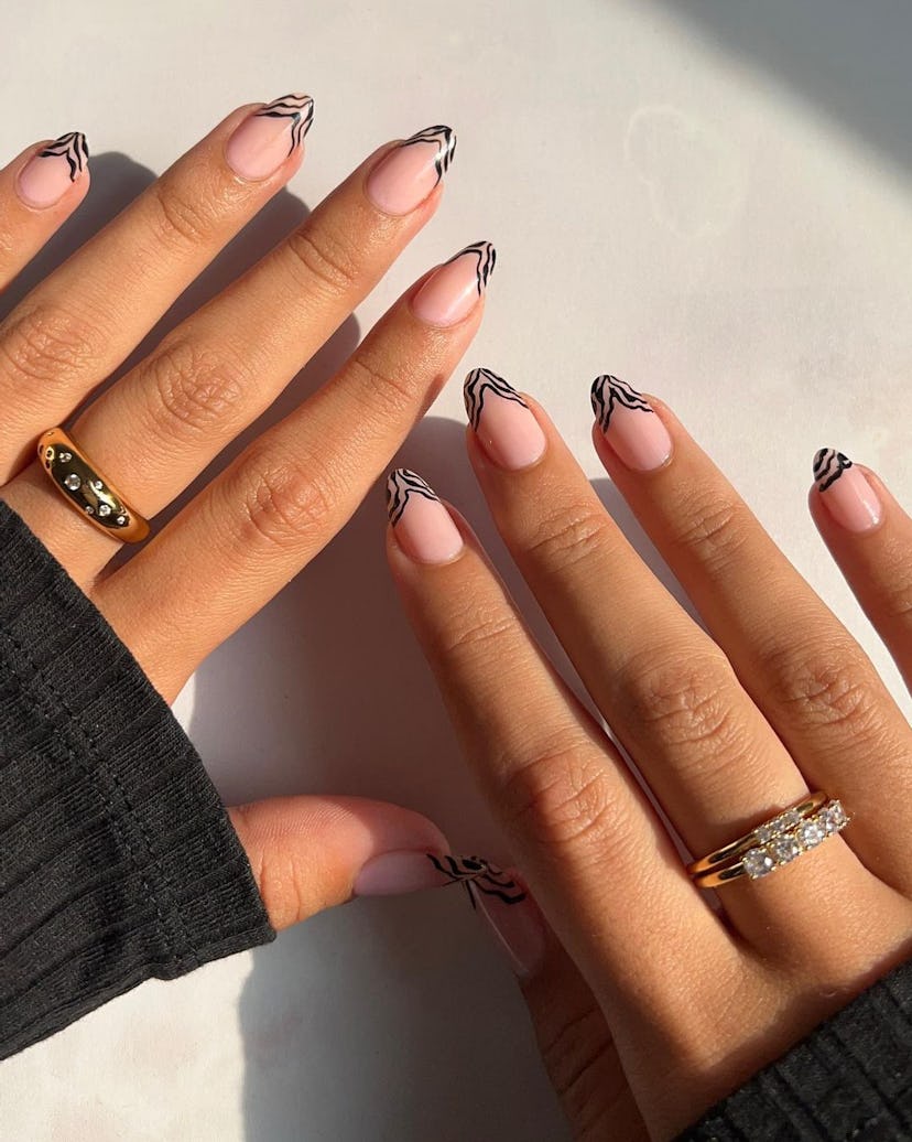 Try almond-shaped zebra print French tip nails.