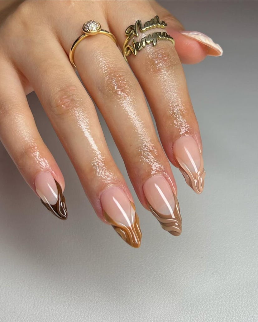 Try almond-shaped neutral French tip nails with 3D details.