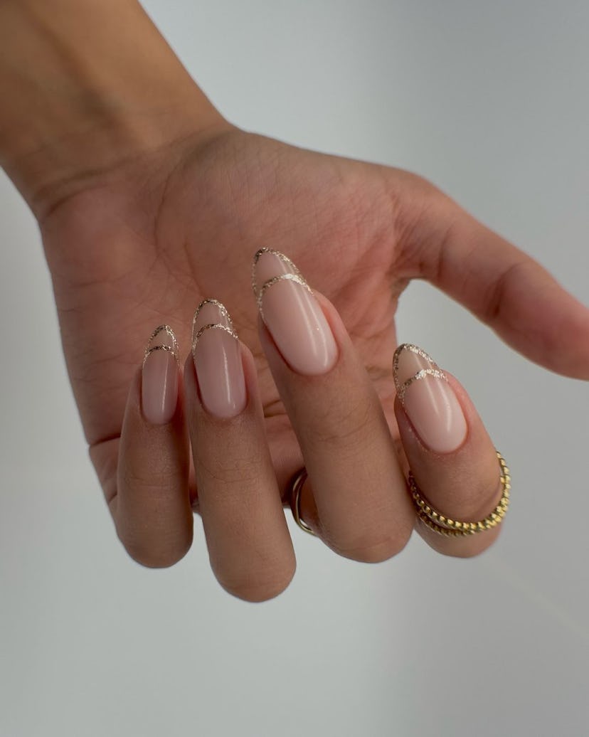 Try almond-shaped invisible French tip nails in sparkling gold.