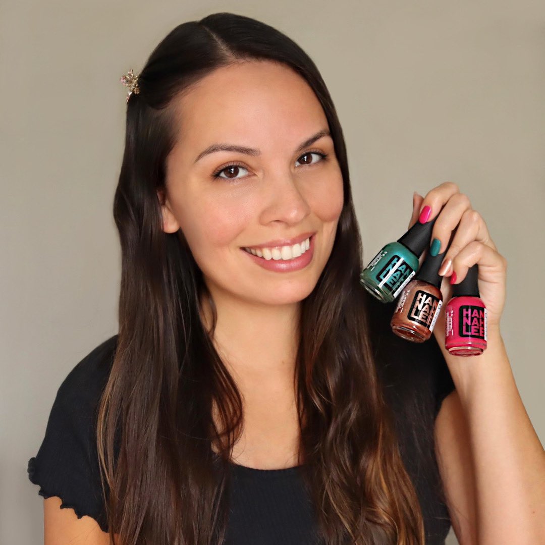 Hannah Lee holding up nail polish bottles