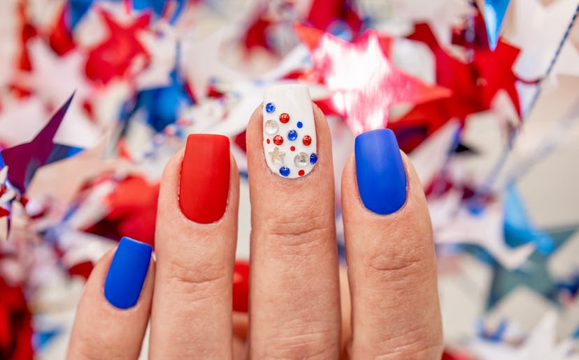 A Fourth of July nail design with jeweled accents.