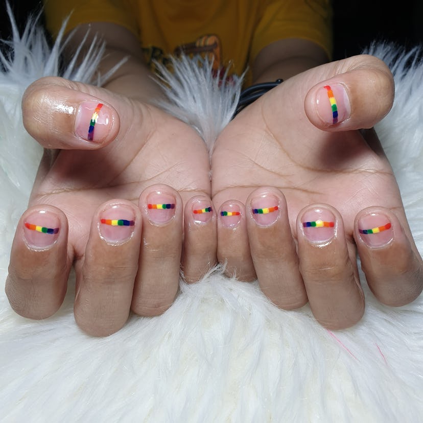 Pride nails with a minimalist-style rainbow stripe across the middle of each nail.