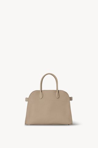 a small tote bag in beige leather