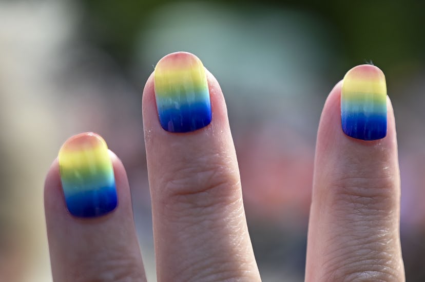 Pride nails painted in rainbow colors.