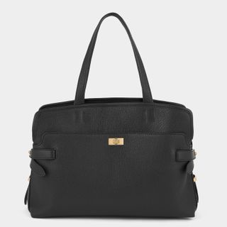 black tote bag with a top handle by Anya Hindmarch