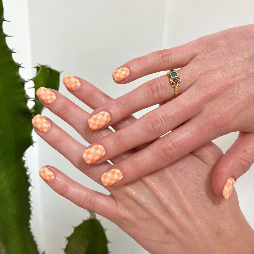 Try a peach gingham print manicure for summer 2024.