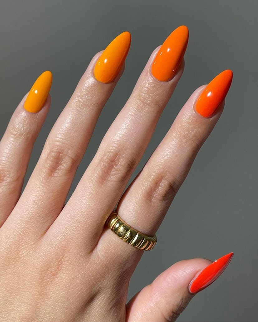 Try an orange ombré manicure for summer 2024.