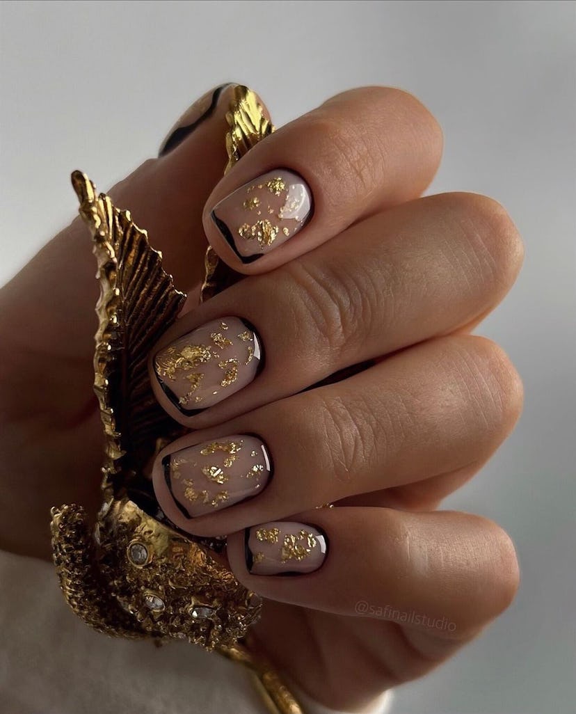 Gold leaf nail art details are perfect for Leo season 2024.