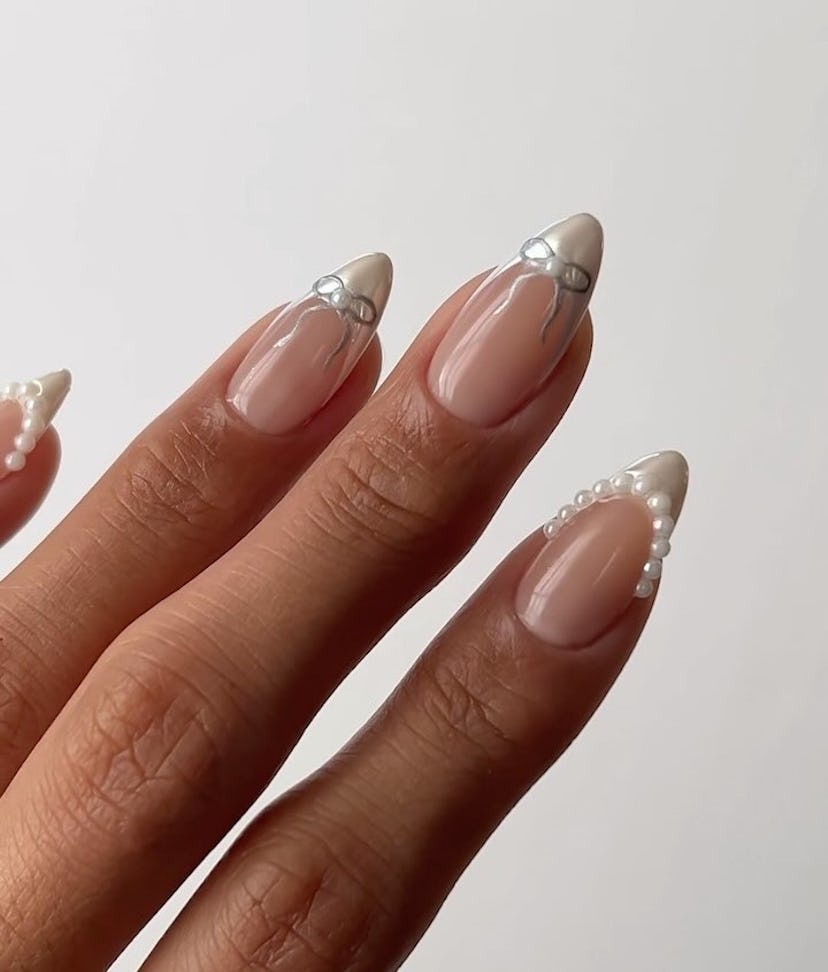 French tip chrome nails with ribbons and pearls are on-trend for summer 2024.