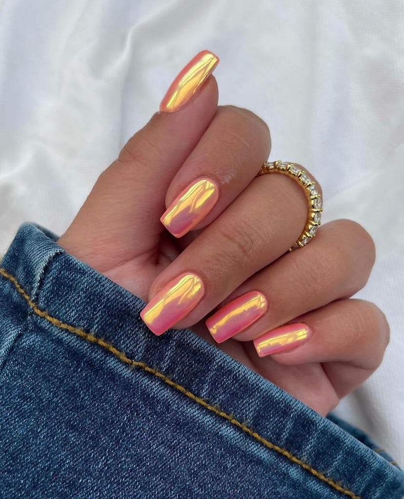 Try orange chrome nails for summer 2024.