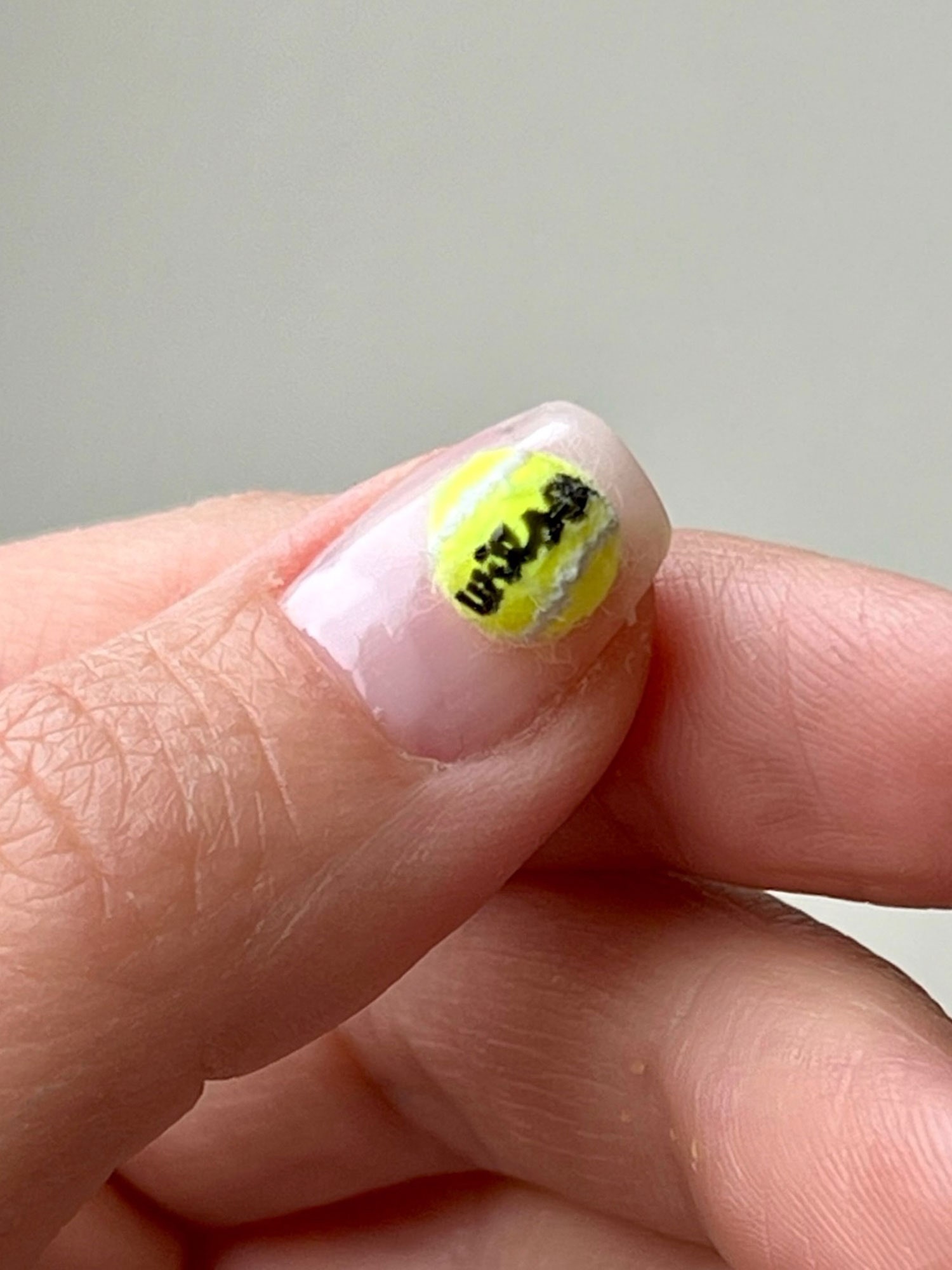 Image may contain Body Part Finger Hand Person Nail Ball Sport Tennis and Tennis Ball