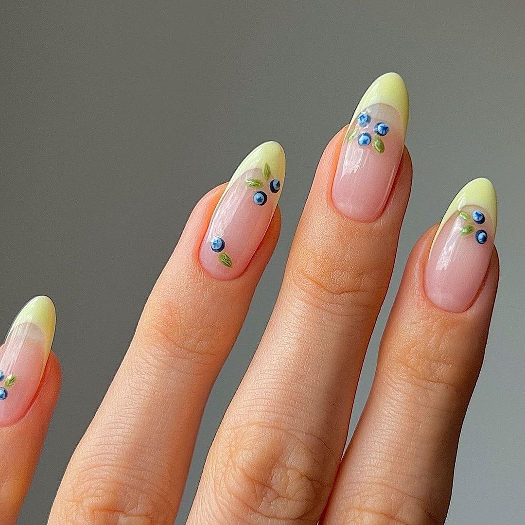 Nails with a lemon yellow tip and dainty blueberries  