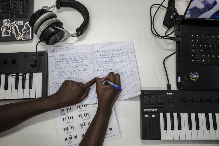 A student takes notes at a beat making class for women in Dakar, Senegal, Wednesday, Aug. 14, 2024. (AP Photo/Annika Hammerschlag)