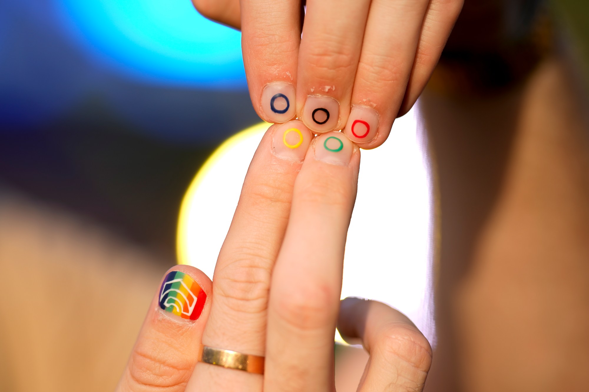 Jeremy Goupille shows his nails painted with the rainbow colors and the Olympic rings at the opening of Pride House, the safe space for the LGBT+ community of athletes, during the 2024 Summer Olympics, Monday, July 29, 2024, in Paris, France. (AP Photo/Natacha Pisarenko)