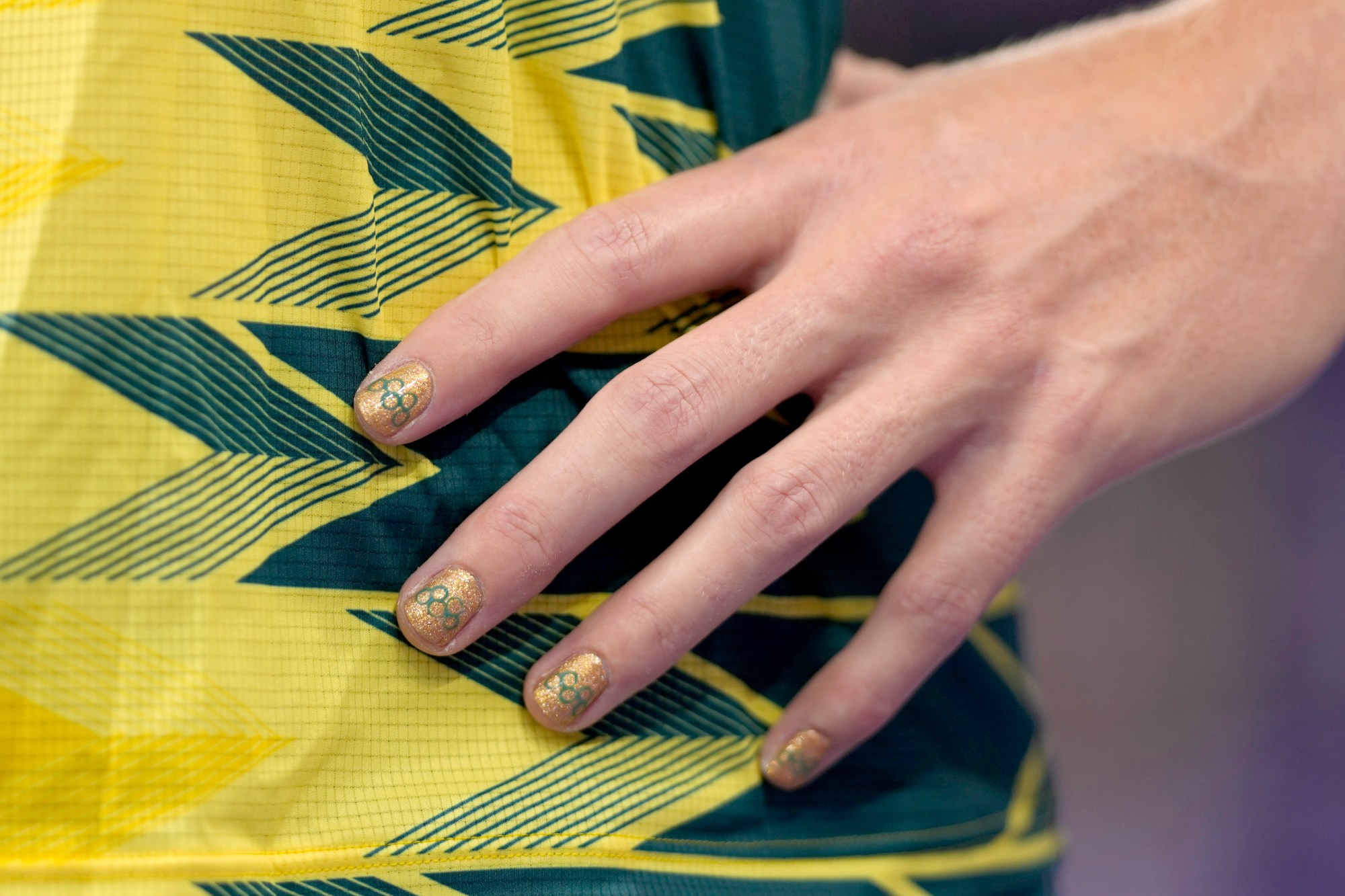 Taryn Gollshewsky, of Australia, wears the Olympic rings on her nails during the women's discus throw qualification at the 2024 Summer Olympics, Friday, Aug. 2, 2024, in Saint-Denis, France. (AP Photo/Bernat Armangue)