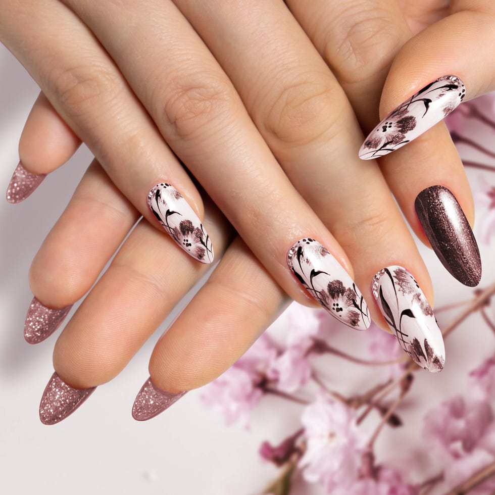 flower nail design brown manicure on sharp long nails close up on a flower background with painted flower design