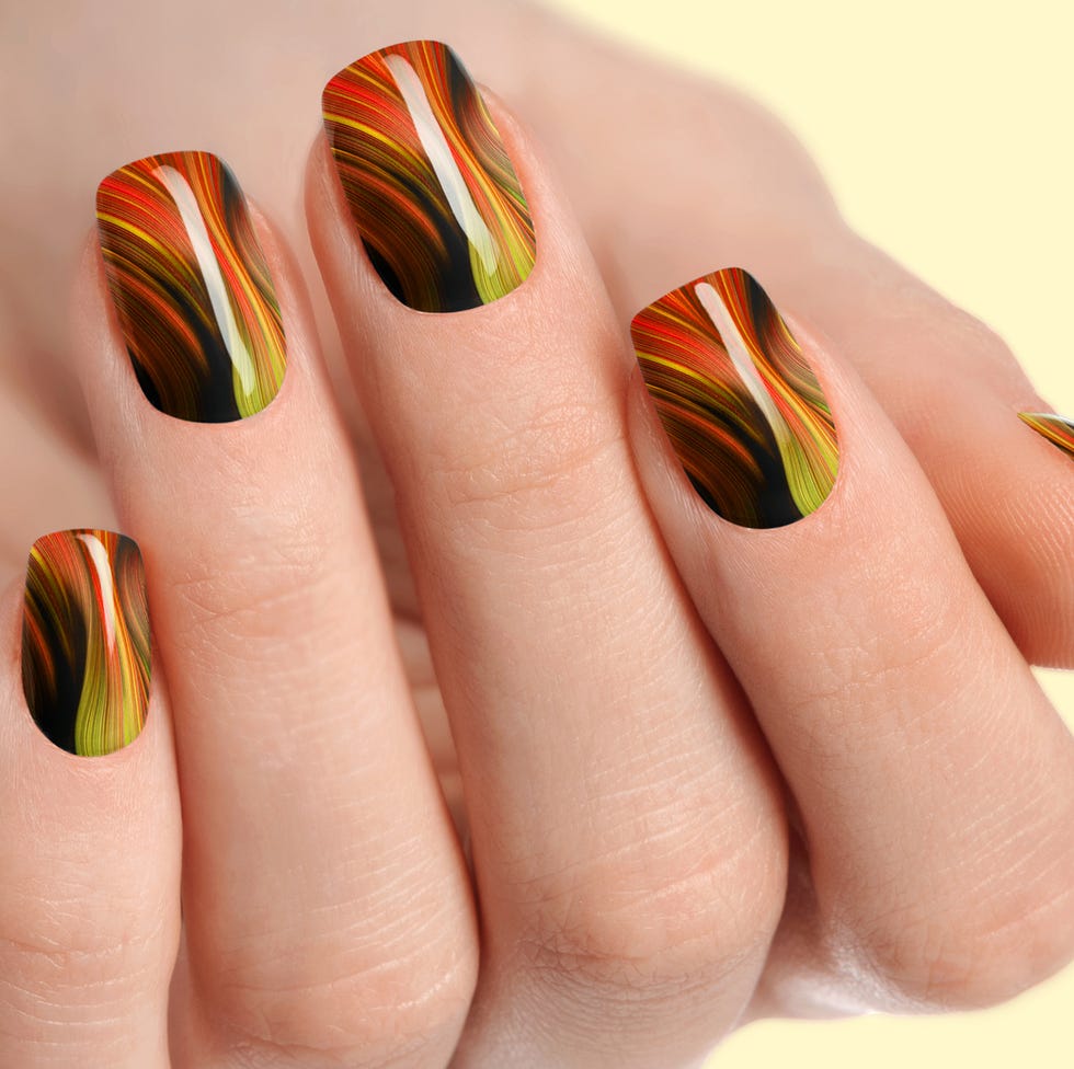 female hands with orange nail design orange nail polish manicure