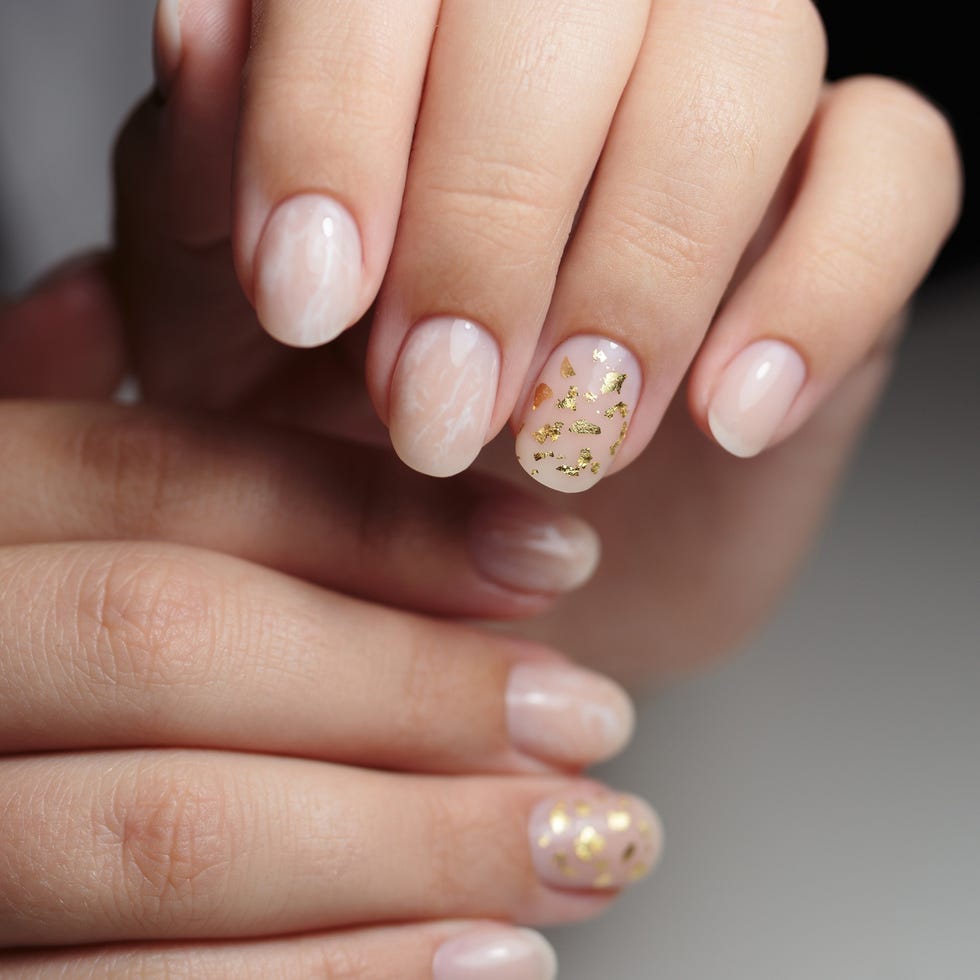 beautiful pink manicure with glitter and gold foil nail design manicure with gel polish close up