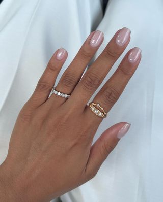 Nail artist Iram Shelton models a milky white, nude manicure