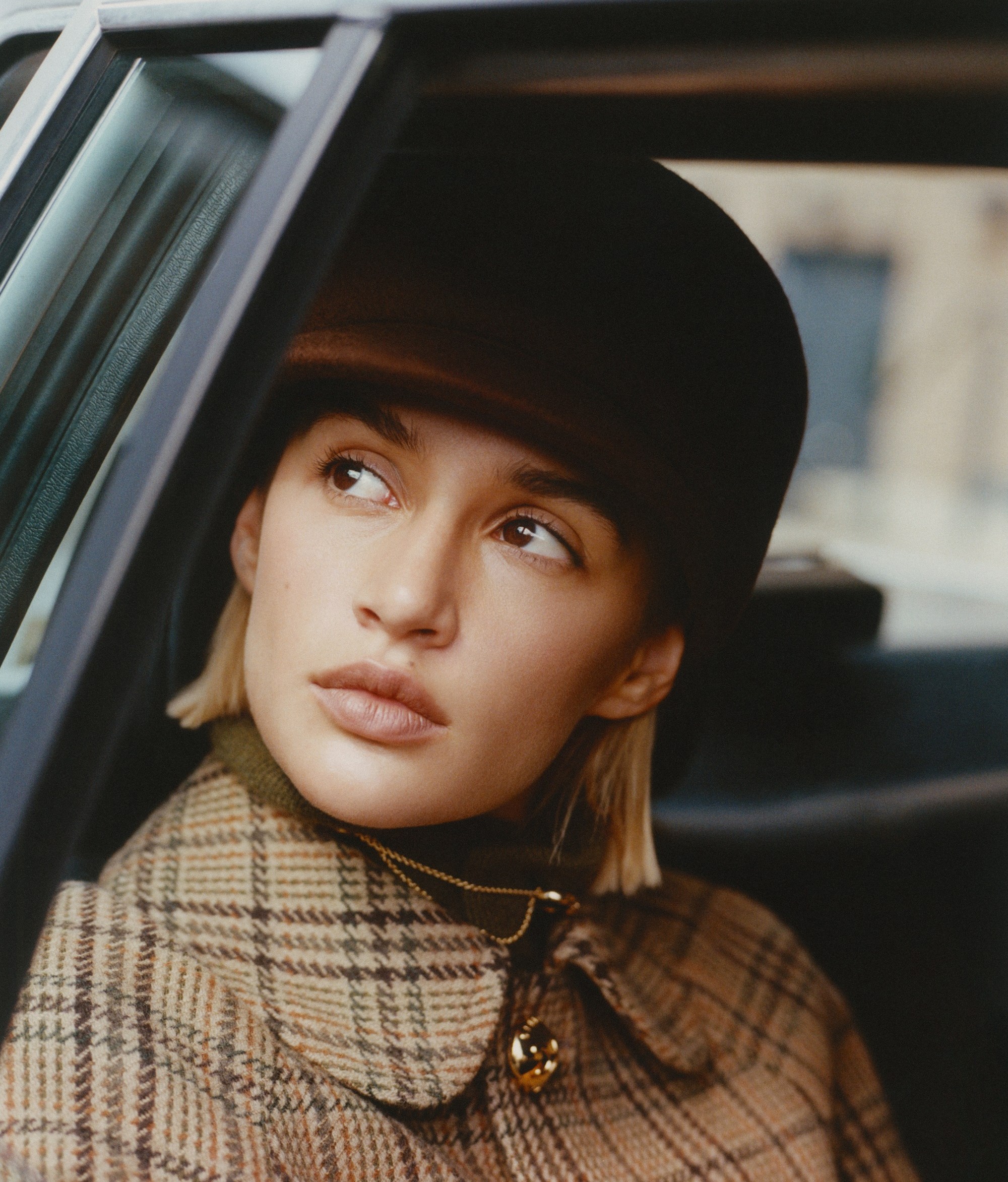 Cashmere jumper, £650, Johnstons of Elgin. Coat, £2,600, and hat, £690, Celine by Hedi Slimane. Panthère de Cartier pocket gem with chain, £7,050, Cartier