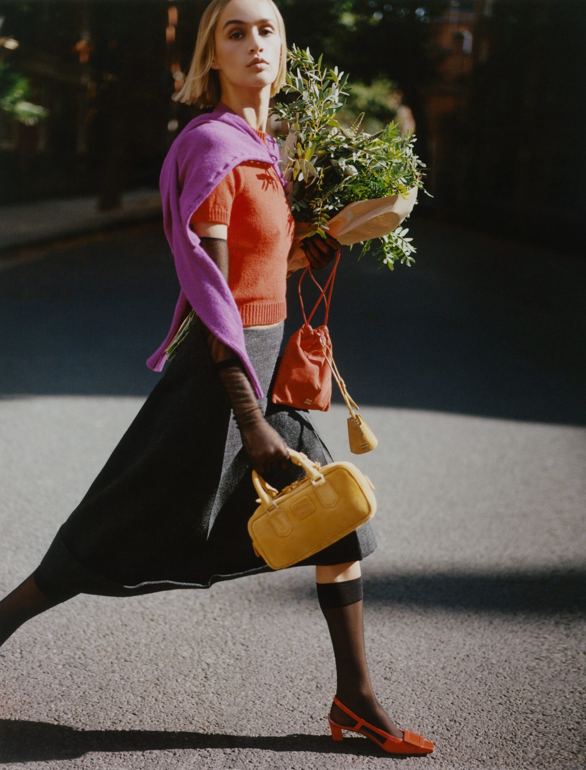 Jumper, £900, cardigan, £1,660, and skirt, £1,560, Prada. Slingbacks, £770, Roger Vivier. Gloves, £530, Khaite. Red pouch, £650, suede keyholder, £360, and Arcadie bag, £2,100, Miu Miu. Socks, stylist’s own