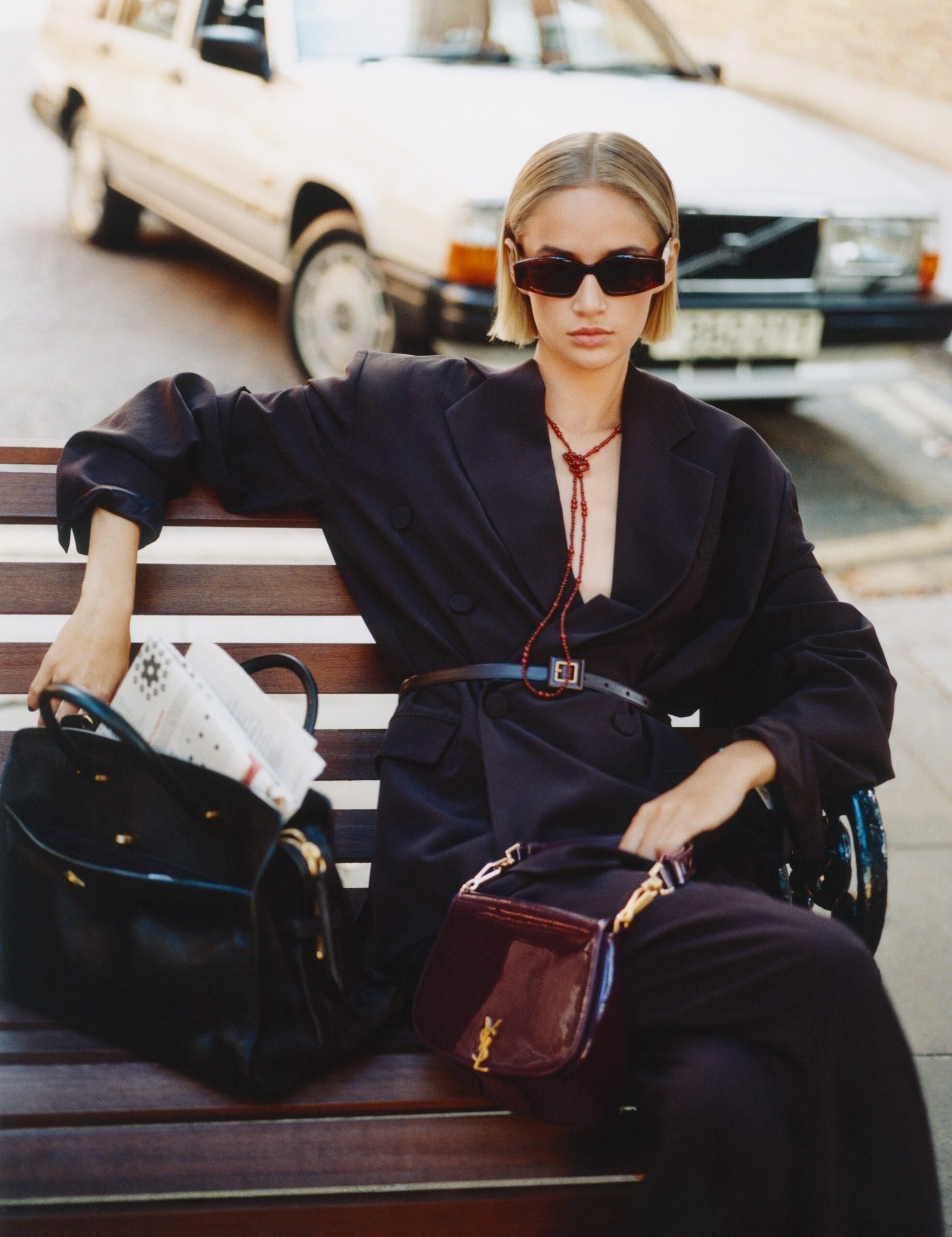 Silk jacket, £3,195, silk trousers, £1,825, belt, £485, and burgundy Voltaire bag, £1,640, Saint Laurent by Anthony Vaccarello. Sunglasses, £270, Alaïa. Black Perriand bag, £3,190, Métier. Necklace, £1,025, Sophie Buhai