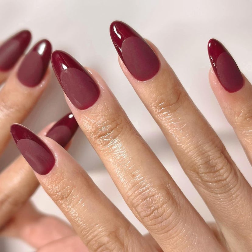 Two-toned cherry mocha French tip nails are on-trend for fall 2024.