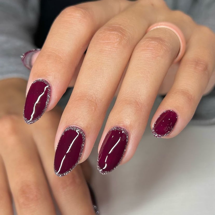 Cherry mocha nails with silver glitter outlines are on-trend for fall 2024.