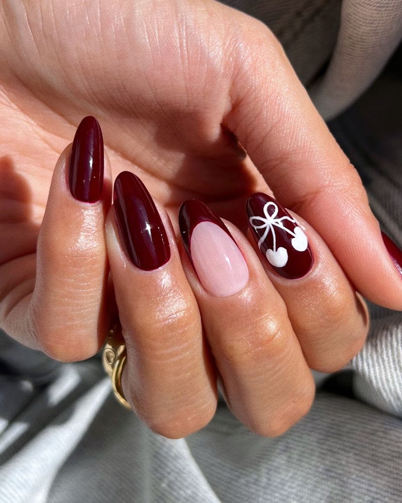 Cherry mocha nails with simple cherry art are on-trend for fall 2024.