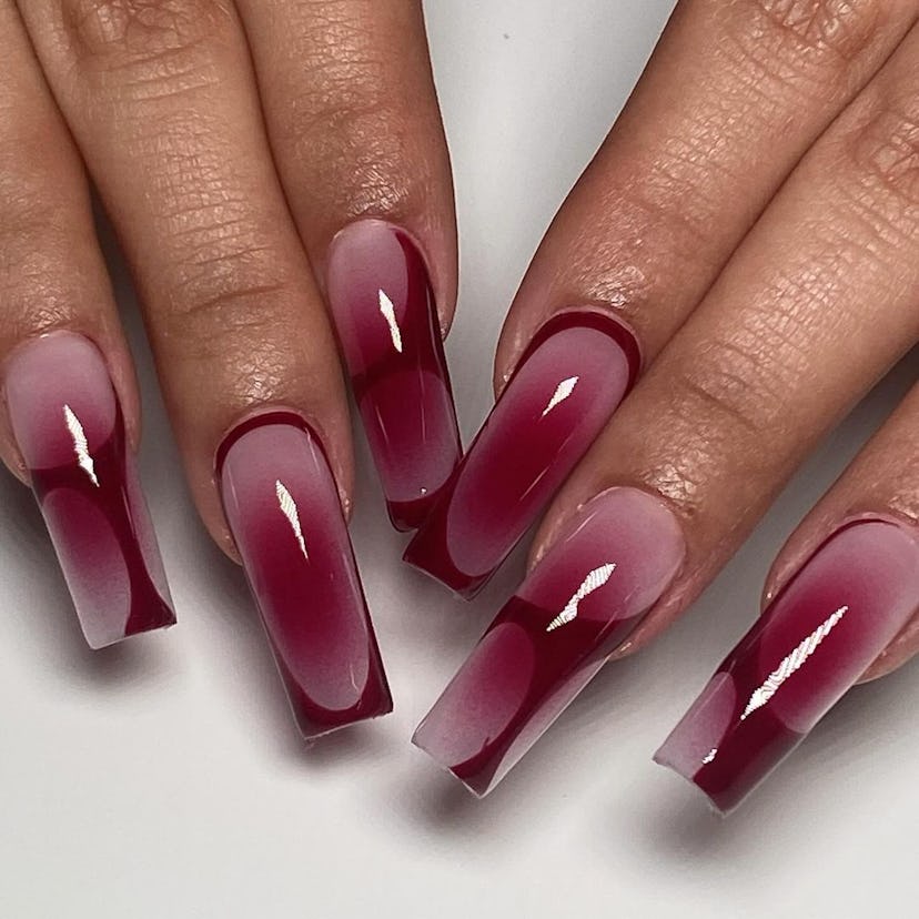 Cherry mocha nails with abstract lines are on-trend for fall 2024.