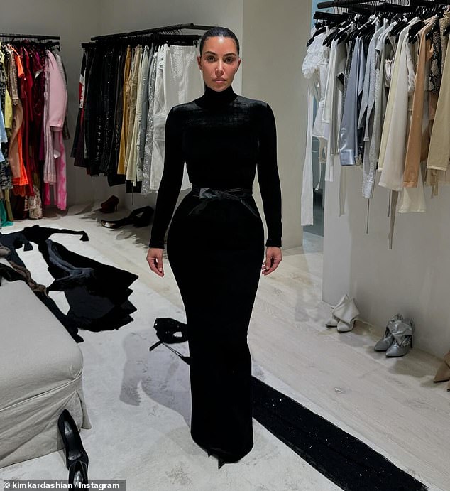 We also see the style maven rock an edgy turtle neck bodycon dress that hugged her curves as she posed in another closet filled with designer looks