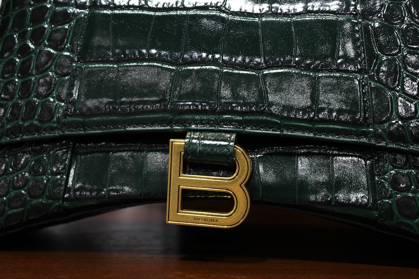 Close up of a brass B that has the name Balenciaga on it