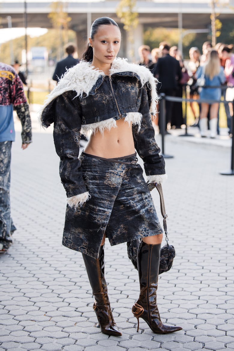 MILAN, ITALY - SEPTEMBER 21: Eva Gutowski, wearing short denim jacket whit fake fur details matchy w...