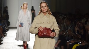 Lauren Hutton at the Bottega Veneta spring 2017 fashion show holding the Hutton 1980 red leather clutch the actress carried in the film 