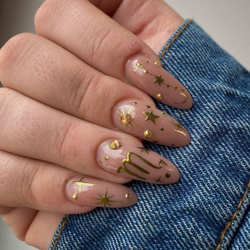 Gilded celestial nail designs are perfect for Scorpio season 2024.