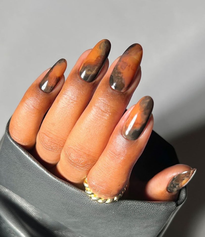 Warm-toned marbled nail art is perfect for Scorpio season 2024.