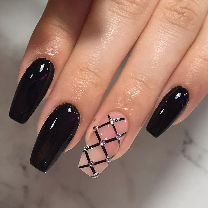 Black fishnet nail art matches the the dark coquette trend.