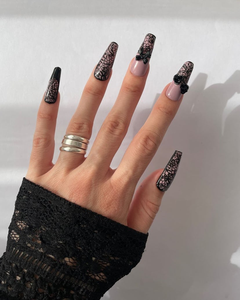 Black lace nail art matches the the dark coquette trend.