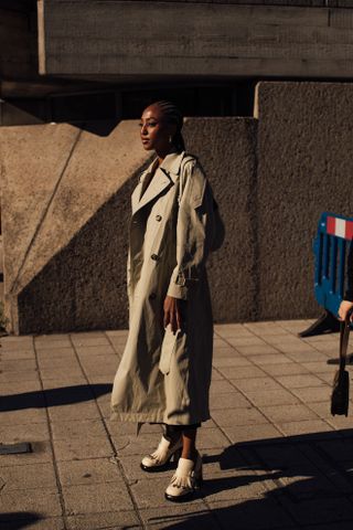 Woman at Fashion Week walking in the street wearing loafers,