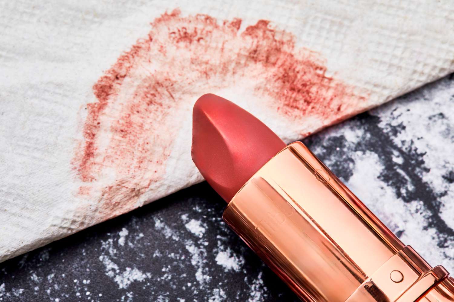 A close up of the Charlotte Tilbury lipstick head and lipstick smear on a napkin