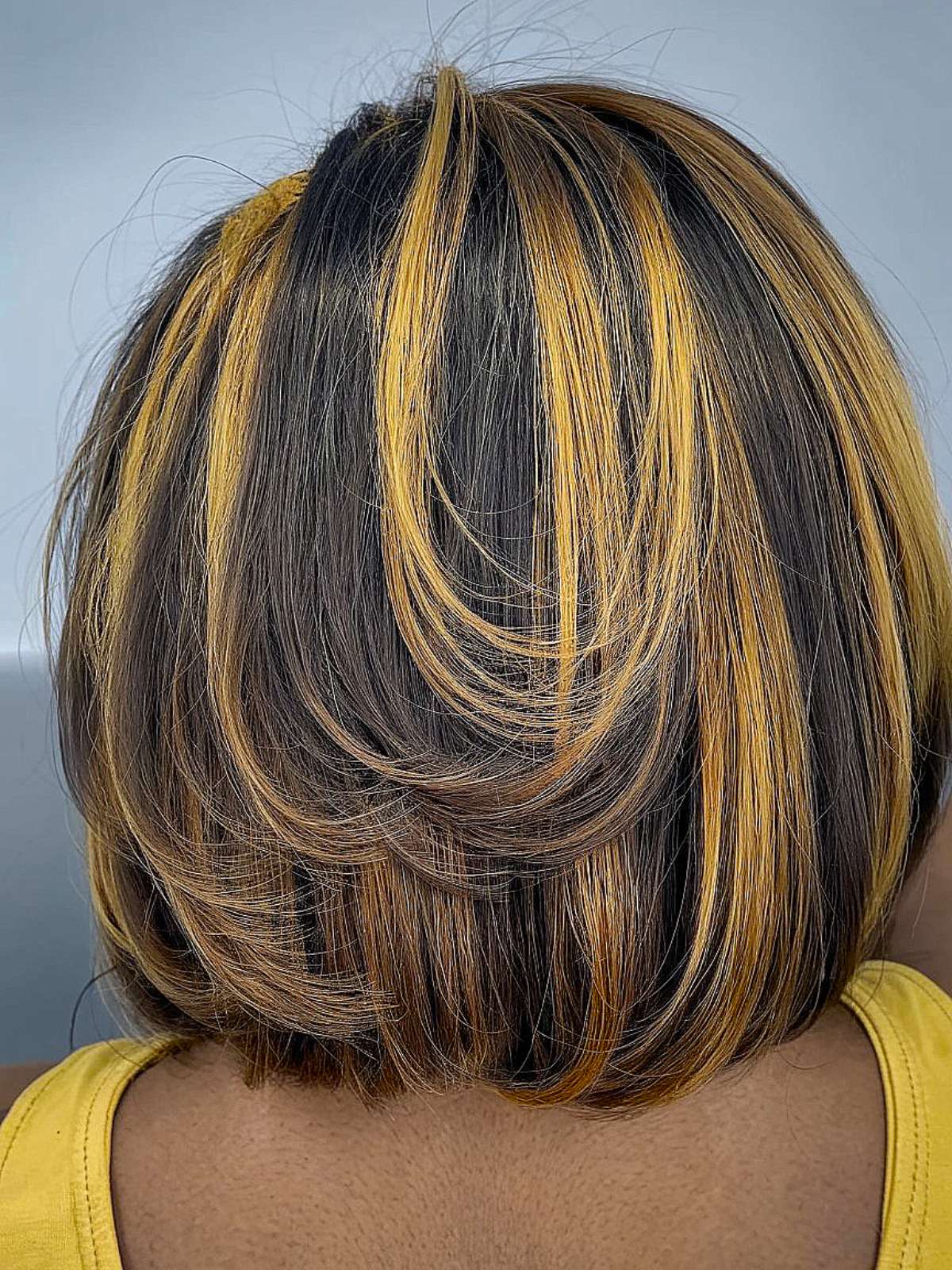 Silk press bob with golden highlights and layered ends