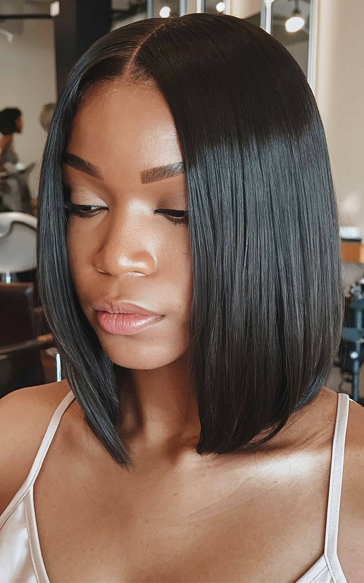 Silk press jet black bob with sleek asymmetrical cut and smooth finish