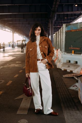 Woman at Fashion Week walking in the street wearing loafers,