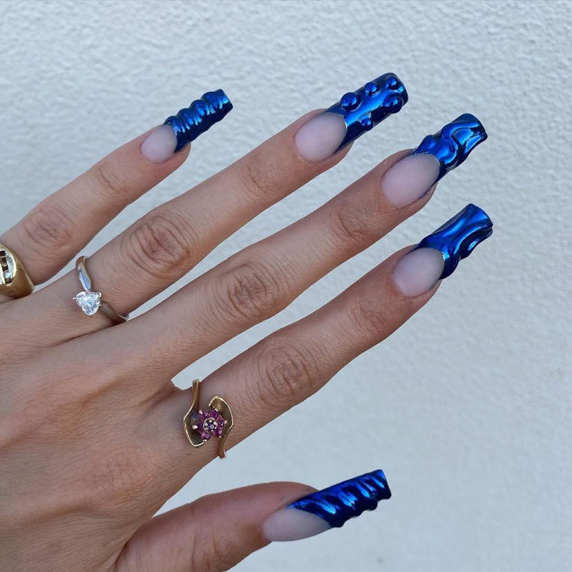 Try sapphire chrome French tip nails with 3D texture.