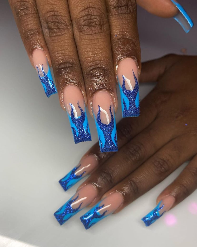 Try blue flame nail art for Sagittarius season 2024.