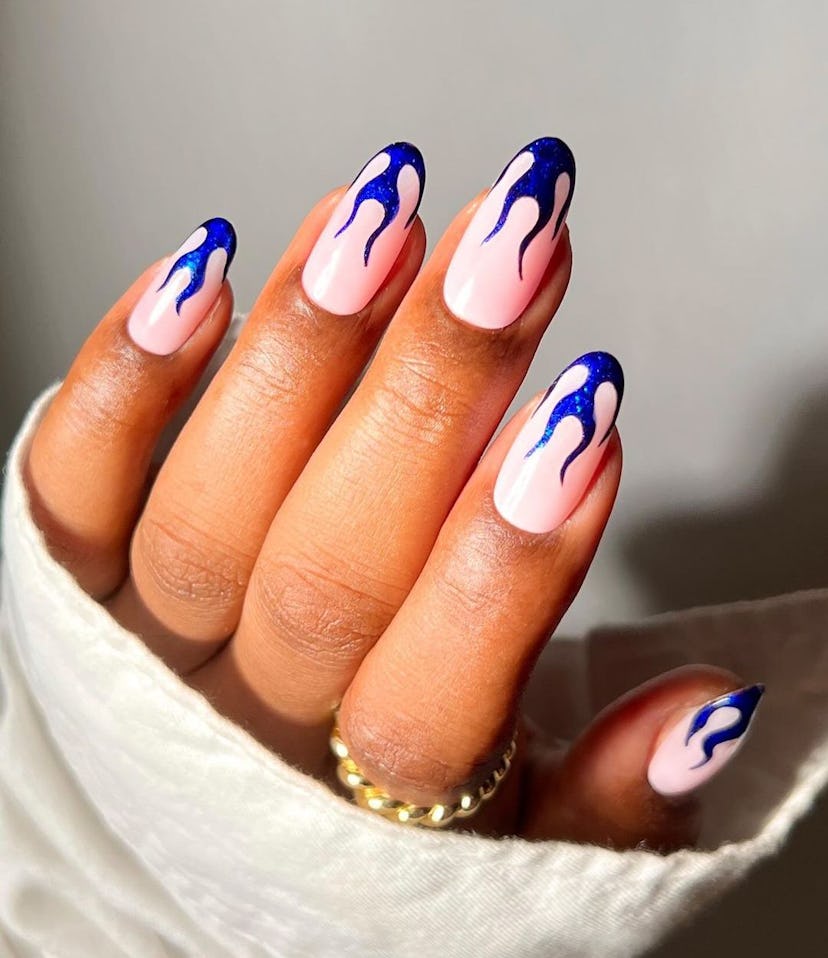 Try dark blue metallic flame nail art.